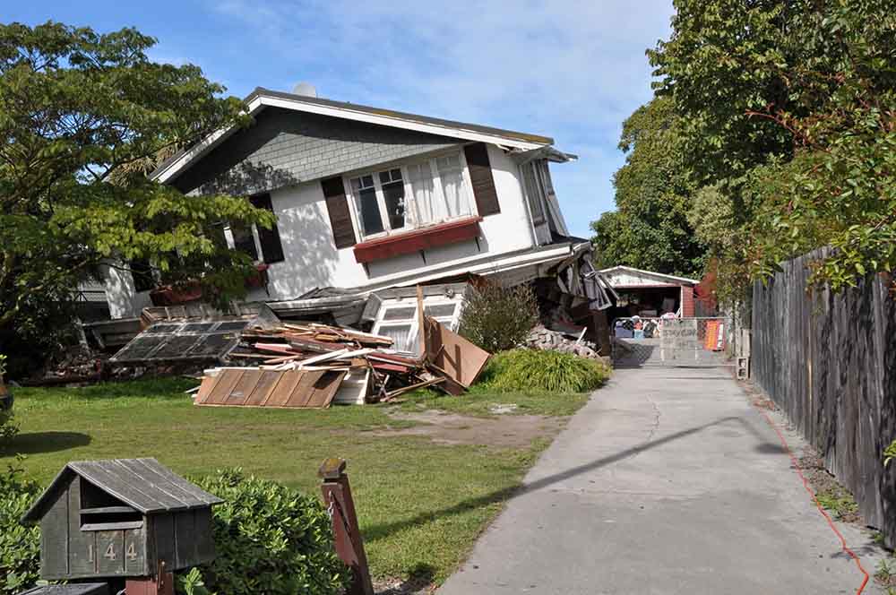 Photo of a house collapsing.