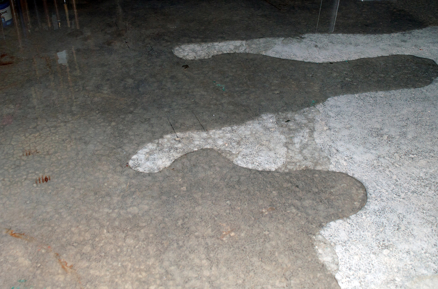 Water pooling and spreading on concrete