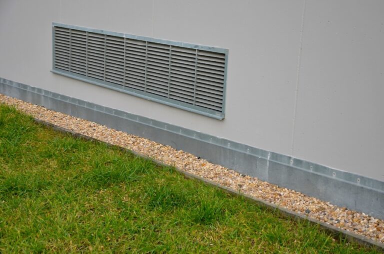 Ventilation grille along the house. basement windows are below ground level.