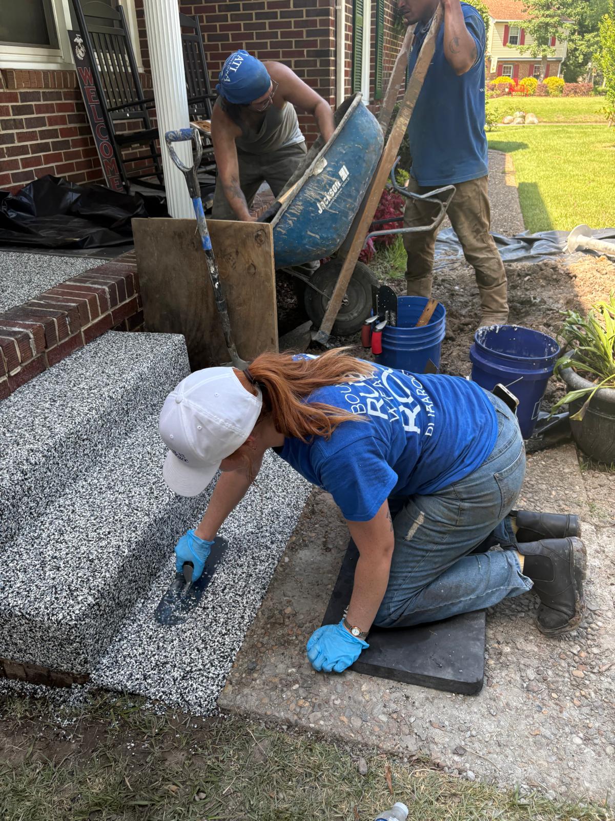 The AMC911 team working to lay down rubber concrete surface