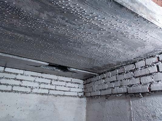 Moisture droplets collecting on the ceiling of a basement or crawlspace.
