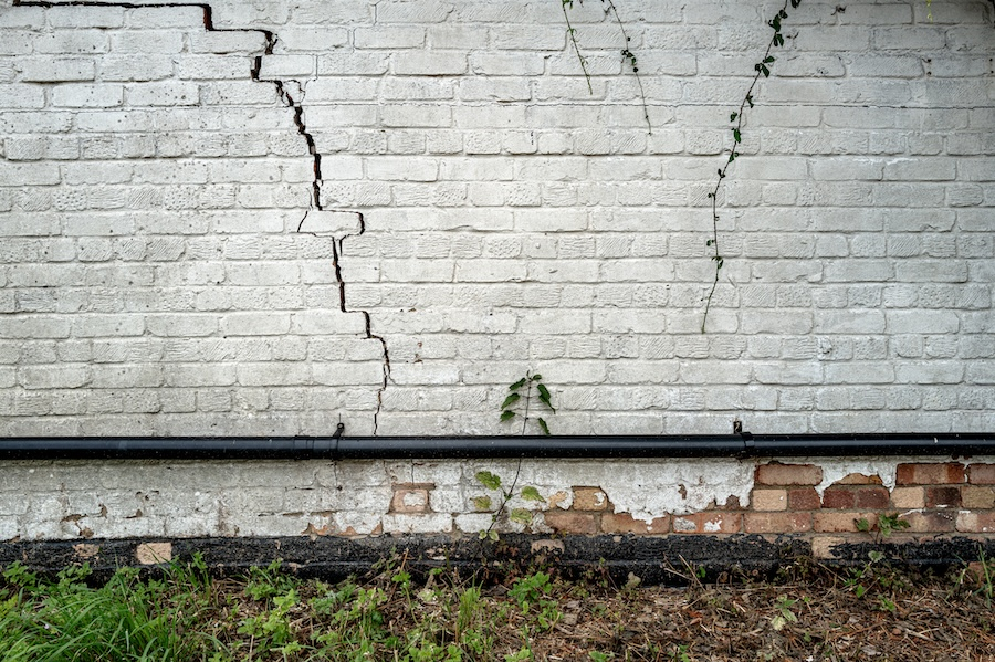 Cracked white brick wall