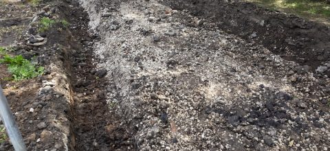 A french drain tunnel dug into gravel