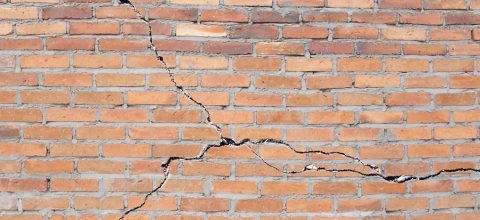 Brick building with cracked foundation