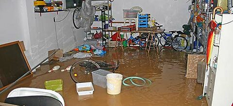 garage with bike and boxes during a flood