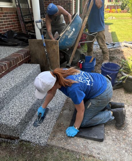 The AMC911 team working to lay down rubber concrete surface