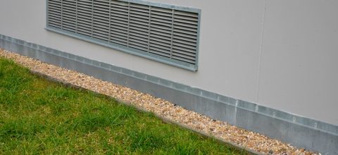 Ventilation grille along the house. basement windows are below ground level.